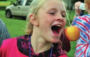 Girl trying to catch apple on string