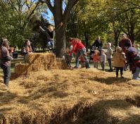 boy jumping off hay bale