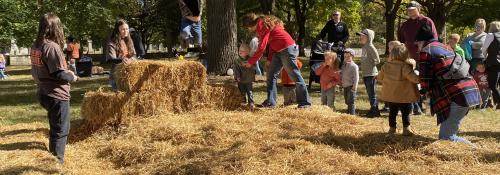 boy jumping off hay bale