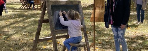 girl drawing on a chalk board